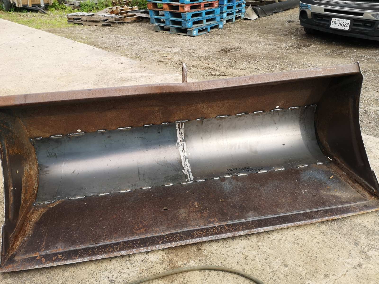 Repaired excavator bucket with new steel plate welded inside, showcasing professional welding and fabrication work in Cambridge