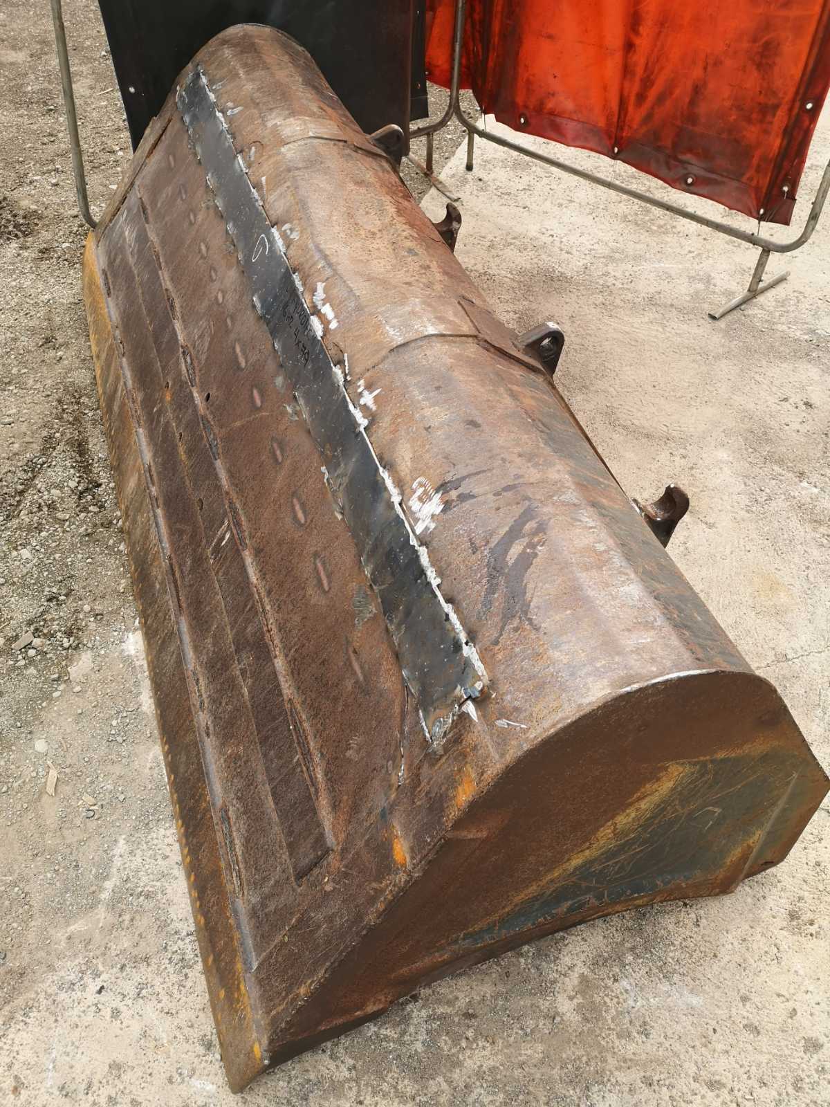 Large steel excavator bucket with reinforced welds and new steel plating, repaired by Cambridge welding and fabrication experts.
